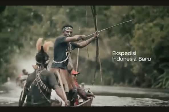 Warga asli Papua di perahu dengan busur dan anak panah