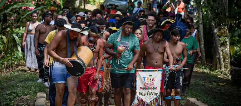 Sebuah kelompok yang terdiri dari masyarakat adat dan keturunan Afro-Brasil pada arak-arakan di hutan hujan