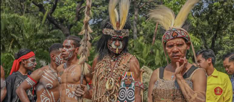 Suku Awyu dengan pakaian tradisional lengkap dengan hiasan kepala dari bulu burung dan lukisan di tubuh